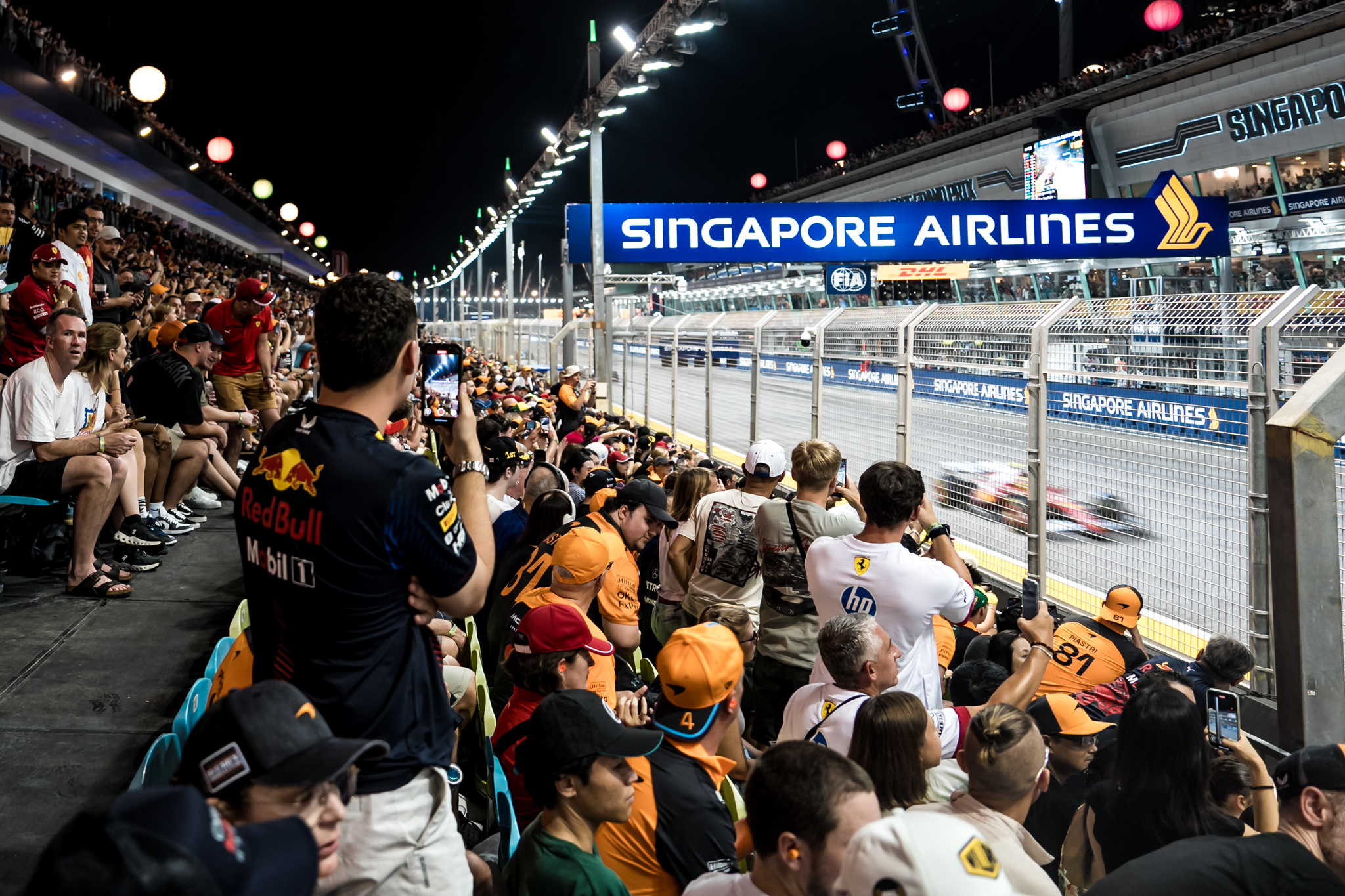 Pit_Camera-ready fans capture shots of the cars racing past-1